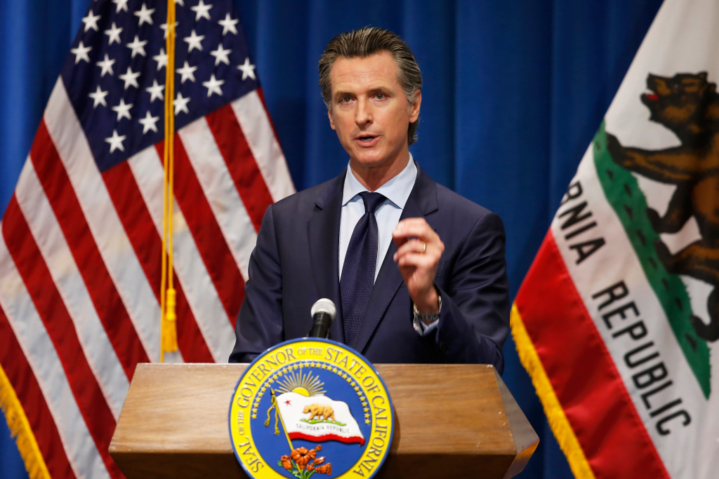 California State Governor Gavin Newsom stands at a podium during a February 2021 press event.