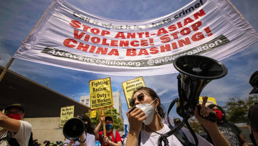 Protesters against anti-Asian violence participate in a May Day march for workers' and human rights in Los Angeles on May 1