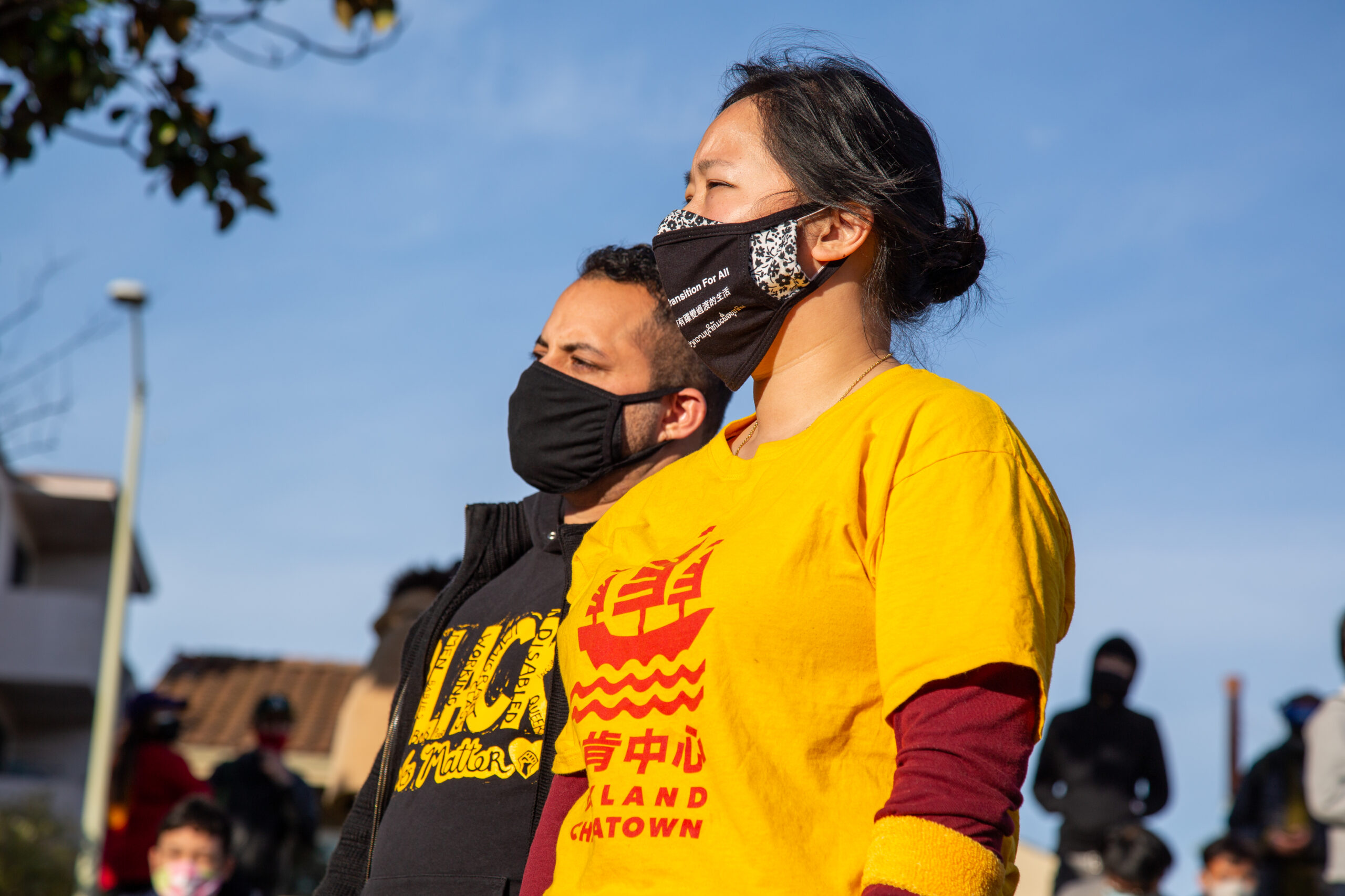 An image of 2 individuals at a Chinatown Rally in Oakland