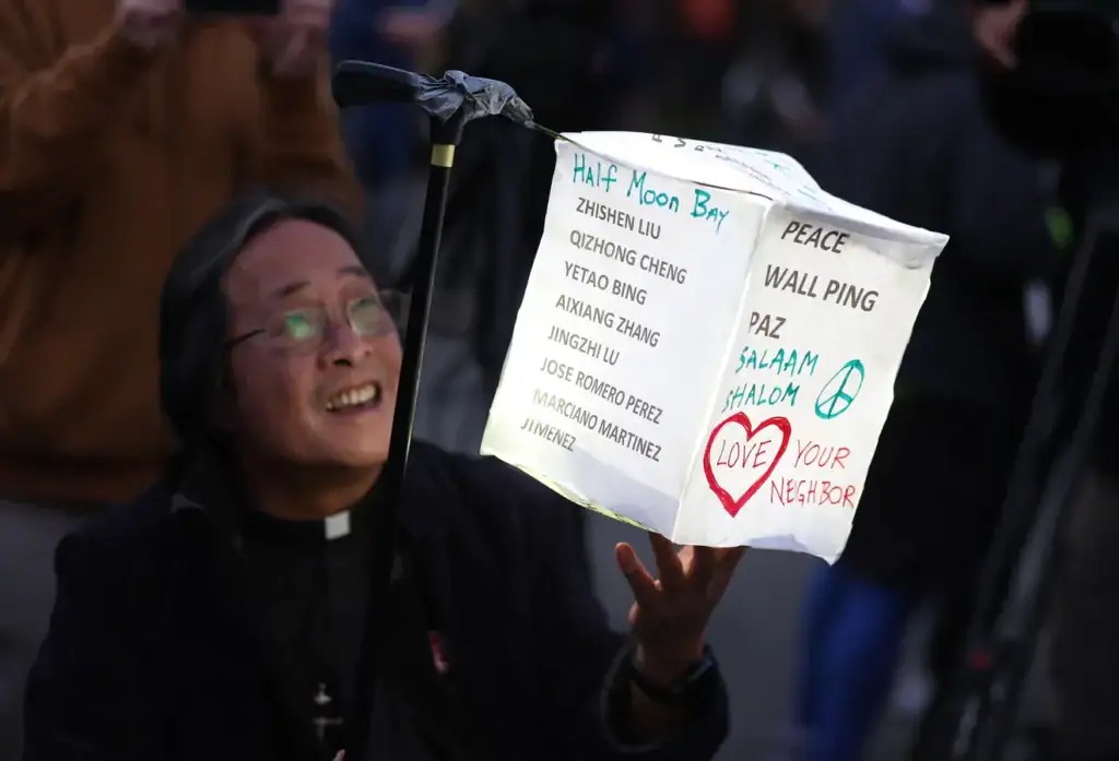Norman Fong holding a vigil lantern.